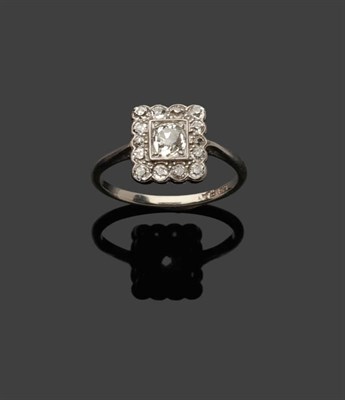 Lot 374 - An Art Deco Cluster Ring, an old cut diamond in a white squared setting within a border of...