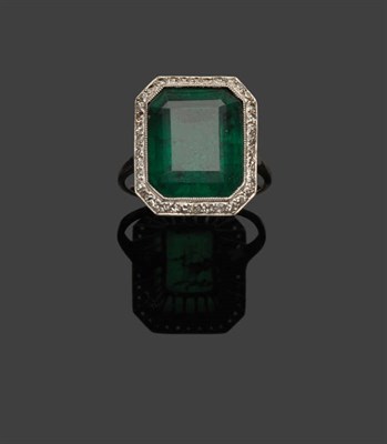 Lot 375 - A Soudé Emerald Ring, the trap cut composite stone within a border of eight-cut diamonds in a...