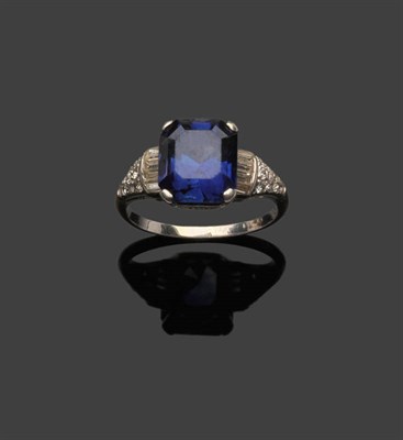 Lot 377 - A Sapphire and Diamond Ring, circa 1920, the octagonal step cut sapphire between shoulders set with