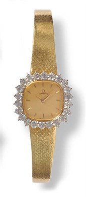 Lot 396 - A Lady's 18ct Gold Diamond Set Wristwatch, signed Omega, circa 1975, quartz movement, gilt dial...