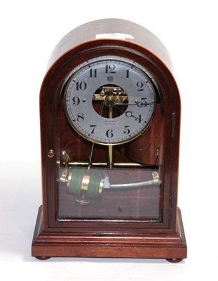 Lot 25 - An electric mahogany veneered case mantel timepiece, silvered dial retailed by Harry Johnson,...