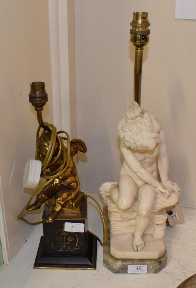 Lot 48 - ^ A gilt metal cherub table lamp, on a black slate plinth; together with a figural table lamp...