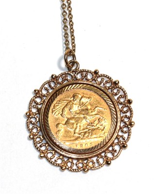 Lot 64 - Edward VII gold sovereign 1902, in 9 carat gold frame, conforming neck chain
