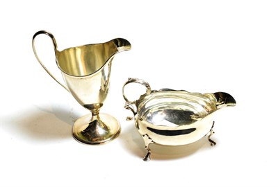 Lot 145 - A George III silver sauceboat and a George III silver cream-jug, the sauceboat by Walter Brind,...