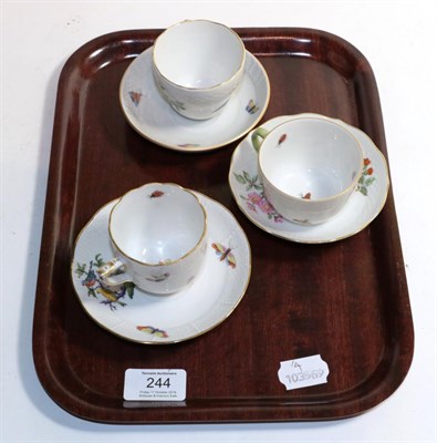 Lot 244 - Two Herend china floral decorated cups and saucers and a Kaiser china cup and saucer