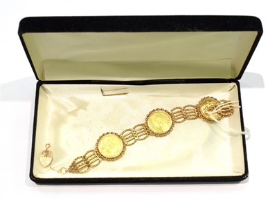 Lot 273 - A 9 carat gold gate link bracelet inset with three half sovereigns, all dated 1897, length 18.5cm