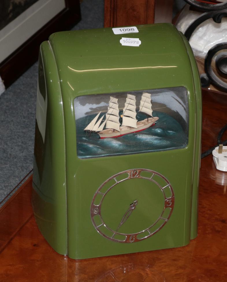 Lot 1098 - A 1930s green bakelite cased Vitascope clock with ship automata