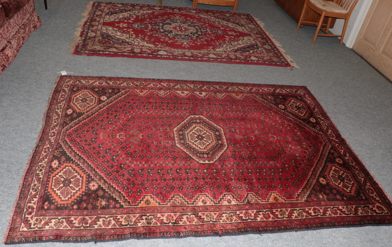 Lot 1121 - Kashgai rug, the scarlet field with central octagon enclosed by narrow ivory borders; together with