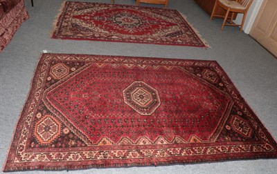 Lot 1121 - Kashgai rug, the scarlet field with central octagon enclosed by narrow ivory borders; together with