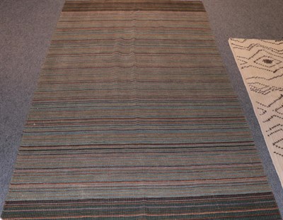 Lot 1123 - Modernist Rug, The abrashed green field with narrow polychrome bands, 247cm by 153cm