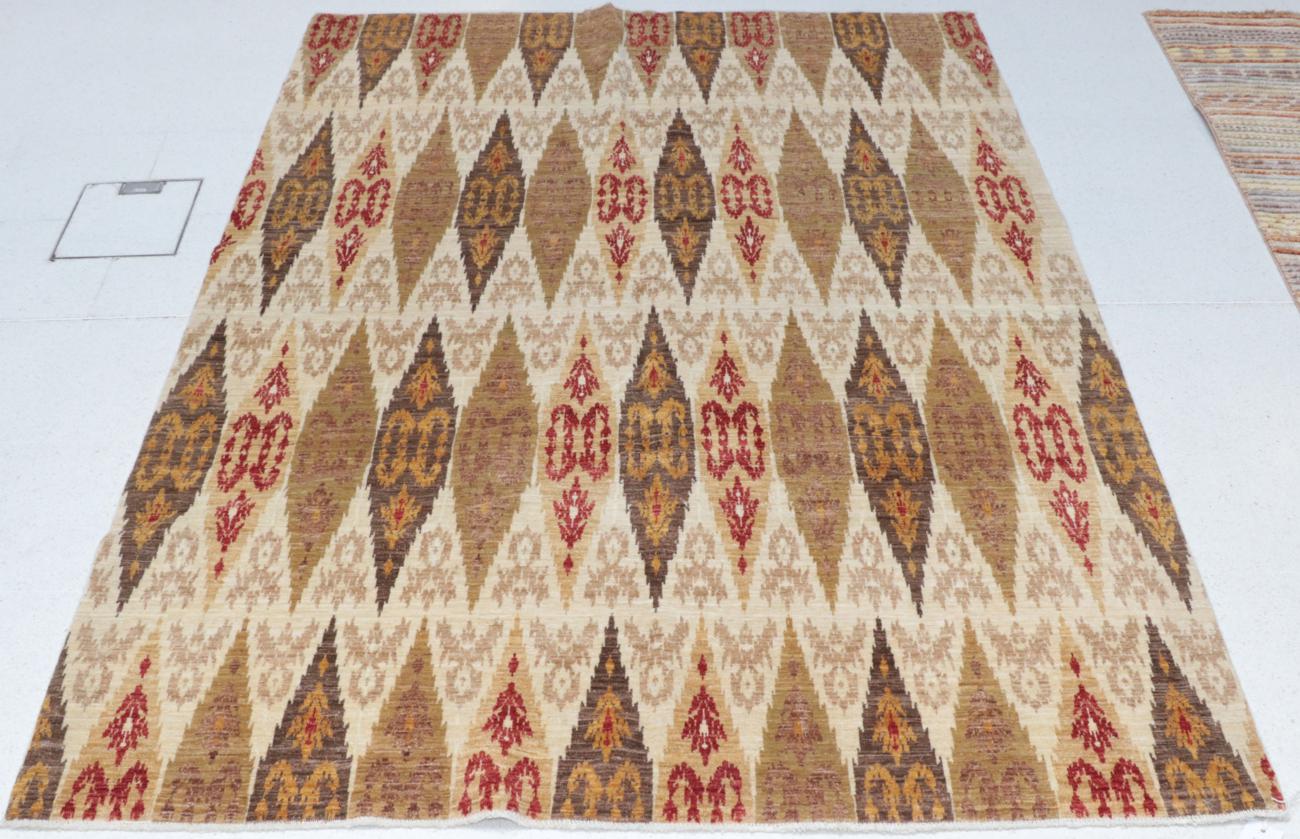 Lot 1126 - Modern Finely Hand-Knotted Rug of Ikat Design, the cream field of serrated oval panels, 207cm...