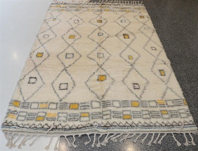 Lot 1127 - Modern Moroccan Hand-Knotted Rug, the ivory field with five columns of linked diamond...