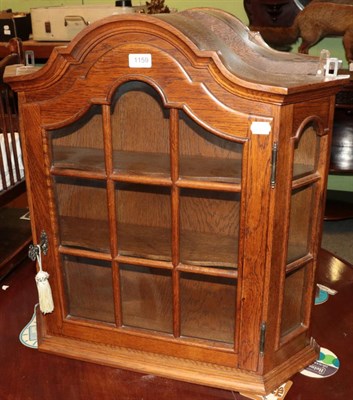 Lot 1159 - A small glazed oak cupboard, and Victorian oak barometer