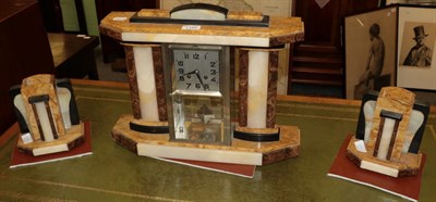Lot 1199 - An Art Deco marble mantel clock with garniture