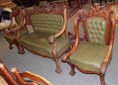 Lot 1202 - An elaborately carved Victorian settee and two chairs