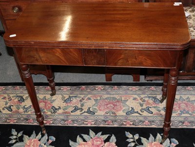 Lot 1225 - ^ A late George III mahogany fold over tea table on ring turned legs, 91cm wide