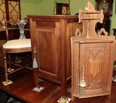Lot 1231 - A small carved oak cupboard and mahogany beside cupboard