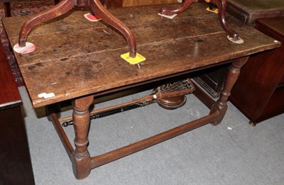 Lot 1233 - A 17th century oak rectangular table with turned legs and block feet joined by a stretcher,...