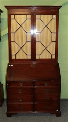 Lot 1267 - A George III style mahogany secretaire bookcase