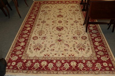 Lot 1295 - Afghan Ziegler design carpet, modern, the ivory field of vines enclosed by blood red meandering...