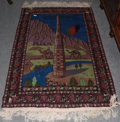 Lot 1296 - Afghan rug, depicting the Minaret of Jam (Central Afghanistan), enclosed by floral borders,...