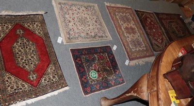 Lot 1297 - ^  Ghom silk rug, the brick red field with central lozenge framed by rosette borders, 83cm by 56cm