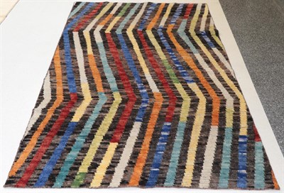 Lot 1303 - Modernist Indian Hand-Knotted Rug, the field comprised of polychrome zigzag bands, 231cm by 140cm