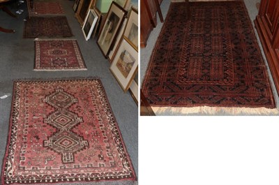 Lot 1312 - ^ A Baluch rug, the midnight blue field with eight panels enclosed by slant leaf borders, 197cm...