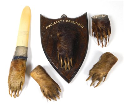 Lot 125 - Taxidermy: A Collection of Badger Paws (Meles meles), circa early 20th century, a sterling...