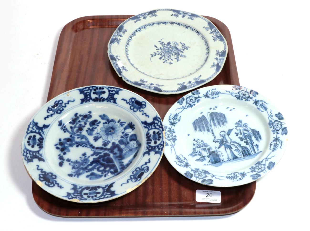 Lot 26 - An English Delft plate, circa 1750, painted in blue with a chinoiserie figure in a garden...