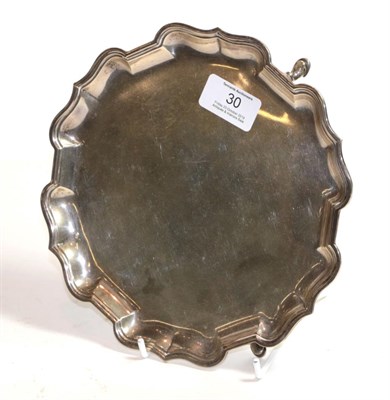 Lot 30 - A George V silver waiter, by Mappin and Webb, London, 1920, shaped circular and on three pad...