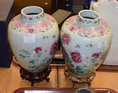 Lot 33 - A pair of Chinese famille rose porcelain vases on pierced hardwood stands, circa 1920