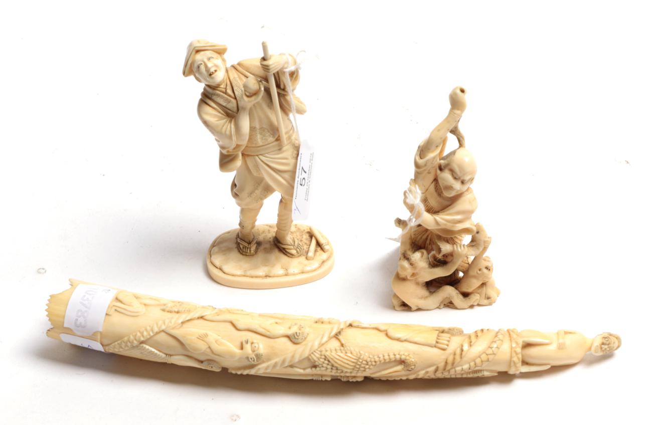 Lot 57 - A carved ivory figure of a man with a staff, a carved Japanese figure with monkey, a carved African