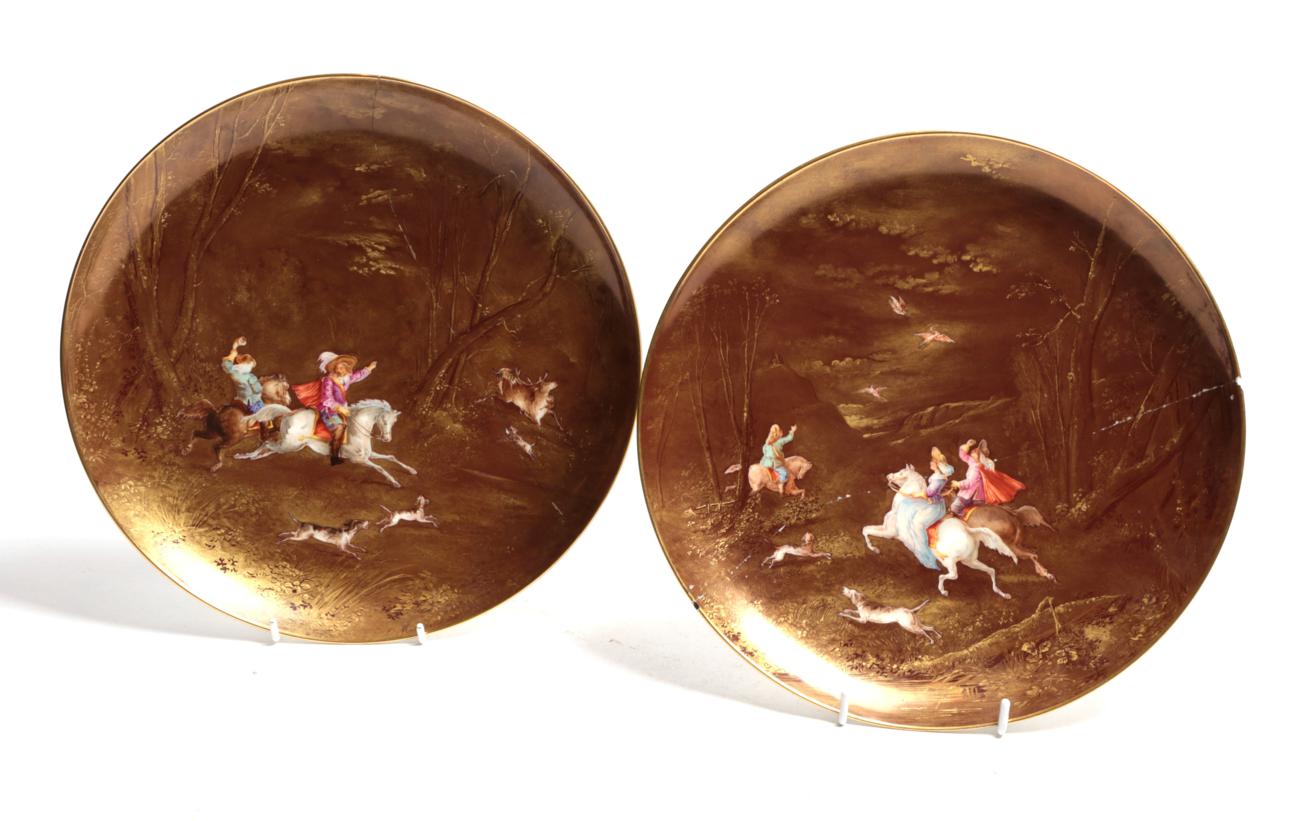 Lot 58 - A pair of 19th century Limoges plates painted with hunting figures on horseback on a monochrome...