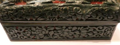 Lot 74 - A Chinese green and cinnabar tixi lacquer box and cover, carved with figures riding camels, a...