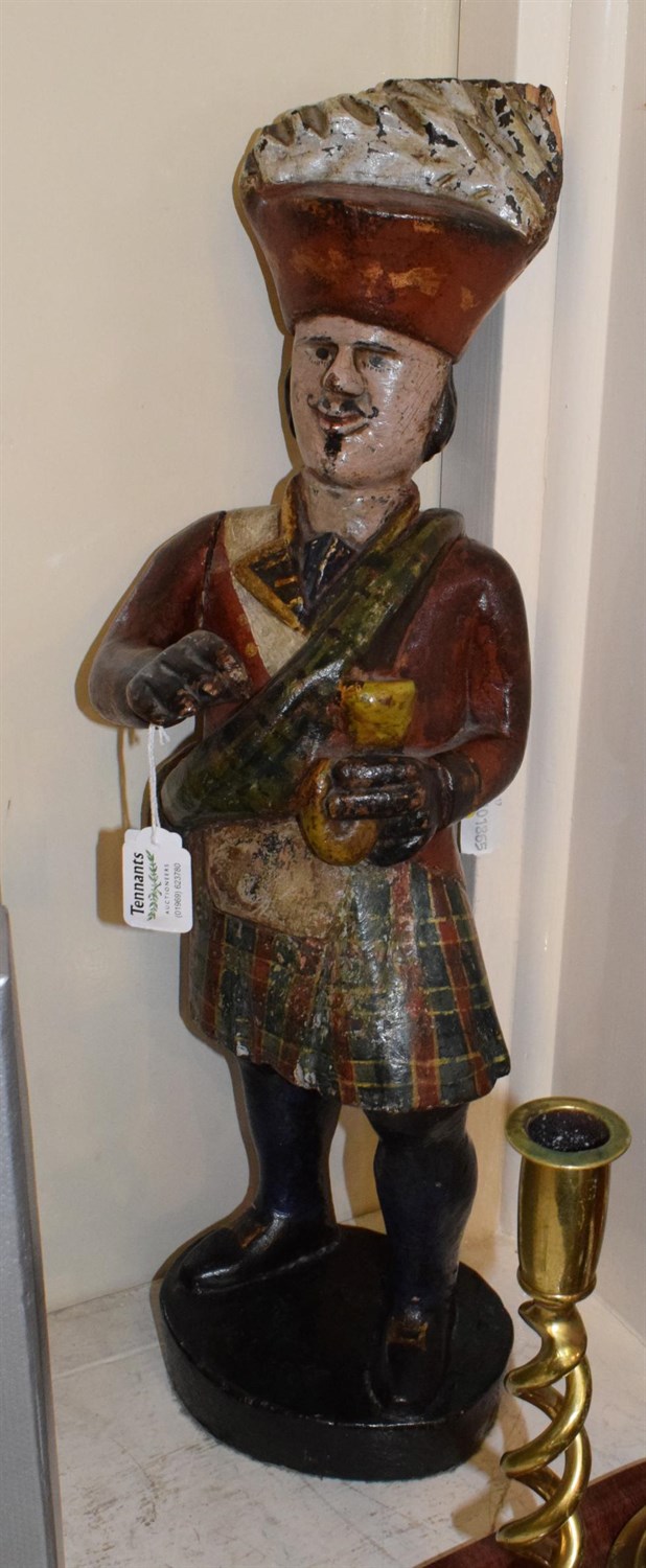 Lot 121 - A carved and painted wood tobacconist advertising figure, modelled as a Highlander in...