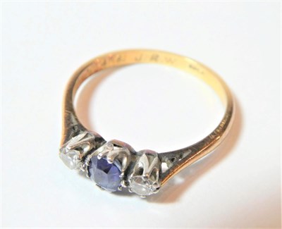 Lot 156 - A sapphire and diamond three stone ring, finger size O