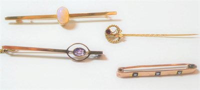 Lot 157 - An opal bar brooch, stamped '15CT', length 6.4cm; an amethyst bar brooch, stamped '9CT', length...