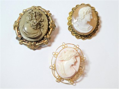 Lot 184 - Two shell cameo brooches, measure 3.2cm by 3.7cm and 3.5cm by 4.1cm (one a.f.); and a lava...