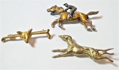 Lot 189 - An enamel and marcasite horse and jockey brooch, stamped 'SILVER', length 5.2cm; a hound...