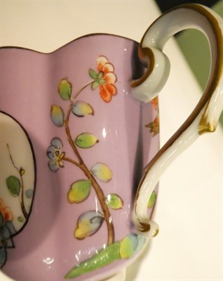 Lot 200 - A Meissen cup and saucer, hand painted in the Chinese famille rose style