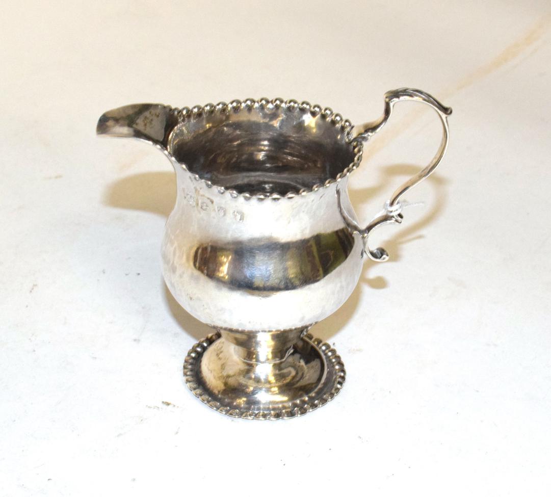 Lot 206 - A George III silver cream-jug, maker's mark NS and AN, London, 1766, baluster and with beaded...