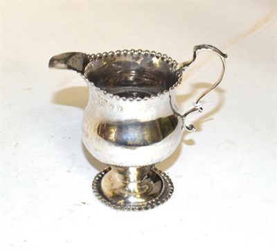 Lot 206 - A George III silver cream-jug, maker's mark NS and AN, London, 1766, baluster and with beaded...