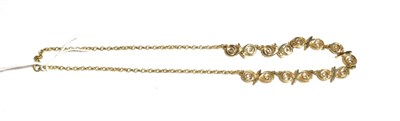 Lot 208 - A 9 carat gold necklace, with seven swirl motifs centrally to a trace link chain, length 42cm