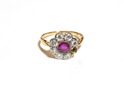 Lot 217 - A ruby and diamond cluster ring, finger size M1/2  One stone loose but present
