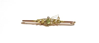 Lot 220 - A peridot and seed pearl bar brooch, stamped '9CT', length 5.7cm