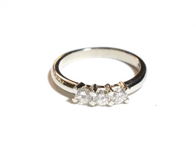 Lot 229 - A platinum diamond three stone ring, three round brilliant cut diamonds in white claw settings to a