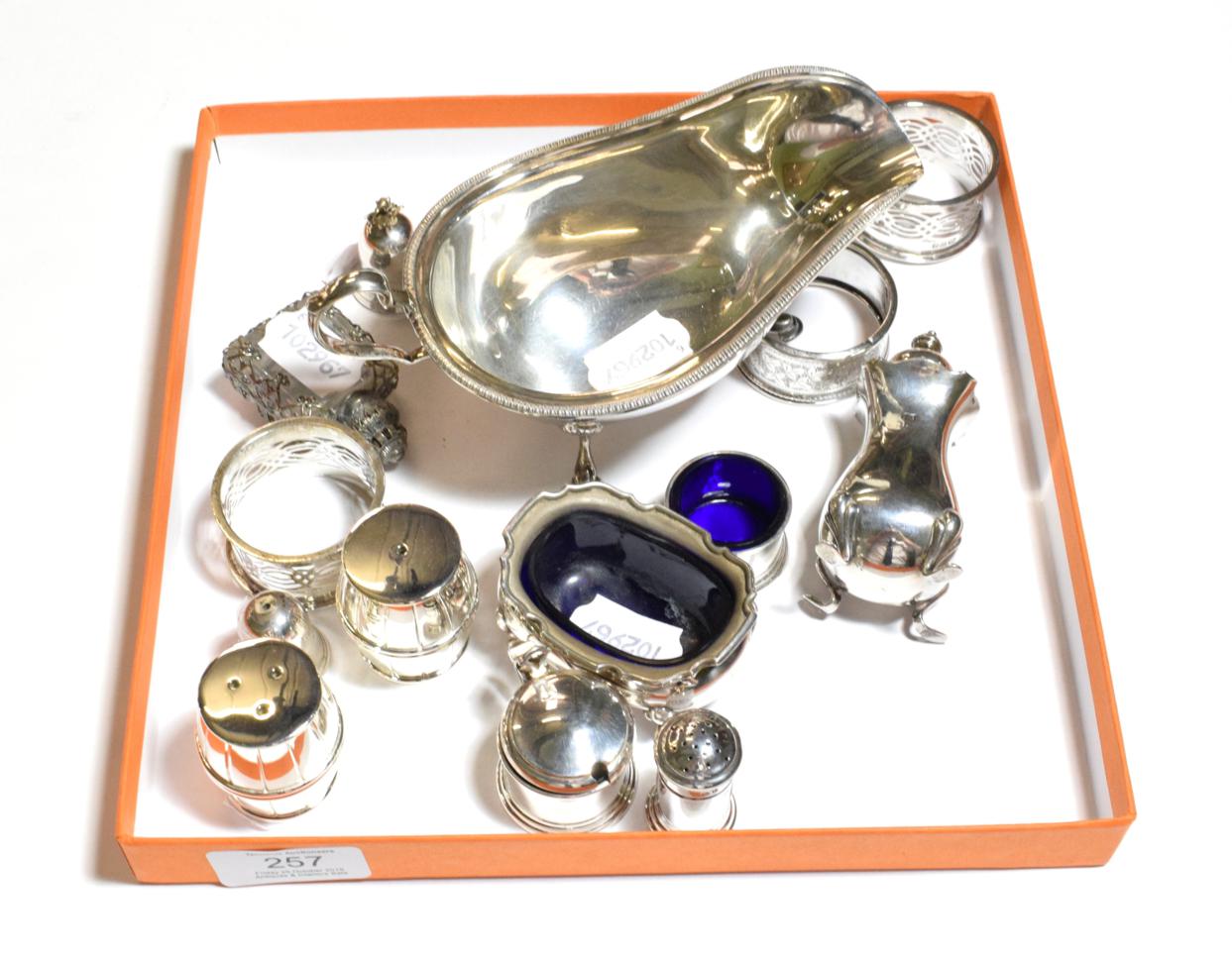 Lot 257 - Assorted silver, including: an Edward VIII silver sauce-boat, Sheffield, 1936; four napkin-kings; a