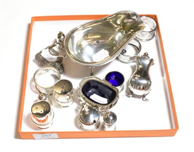 Lot 257 - Assorted silver, including: an Edward VIII silver sauce-boat, Sheffield, 1936; four napkin-kings; a