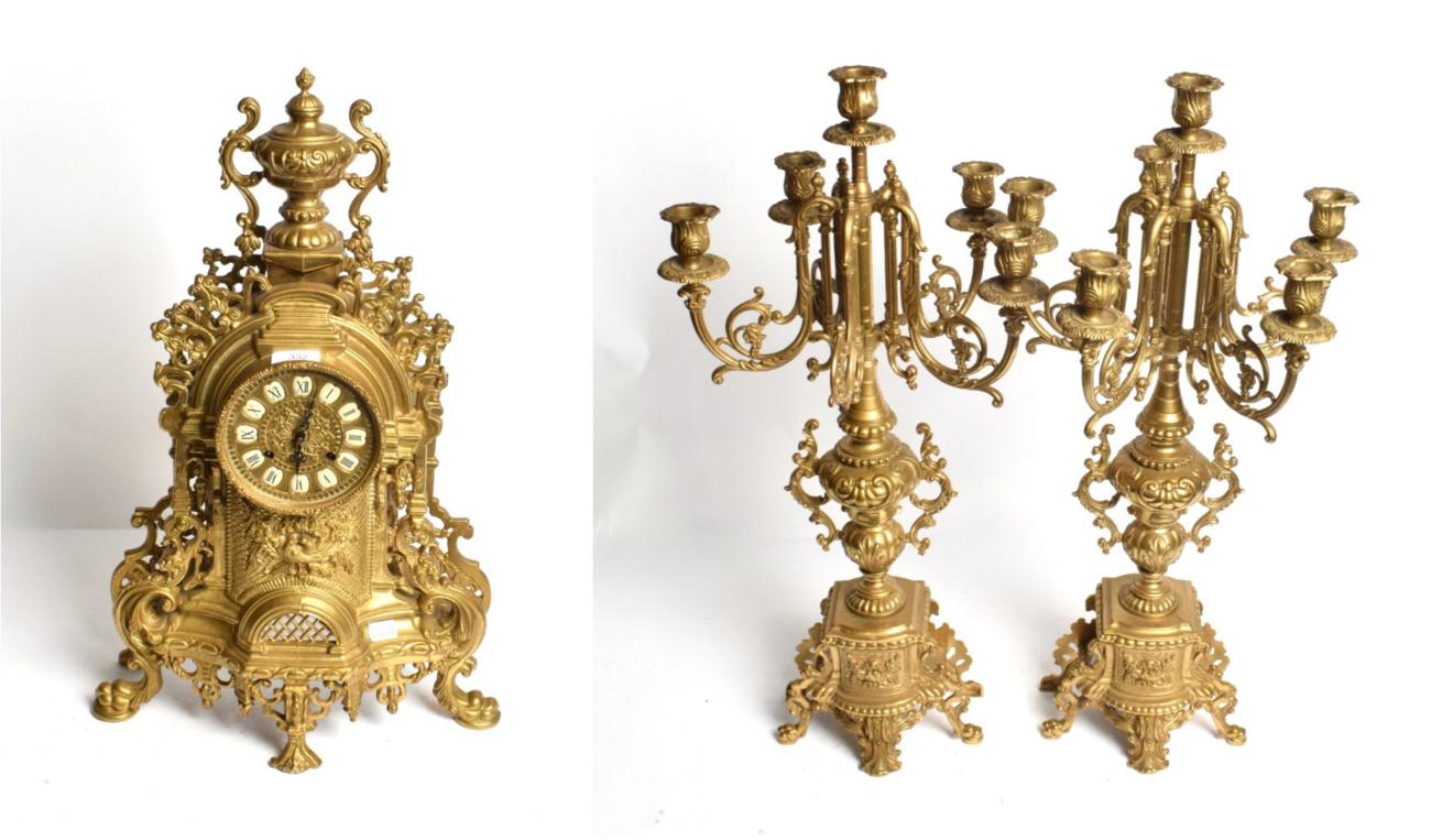 Lot 332 - A modern gilt-metal striking mantle clock and a six light candelabra garniture (3)